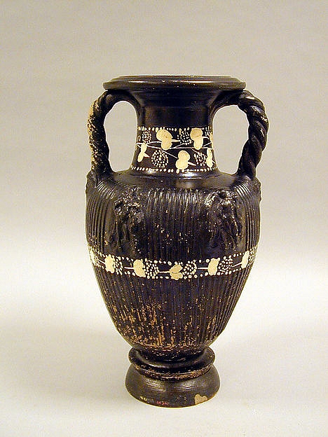 Photo of a black glazed vase with twisted handles and elaborate designs.